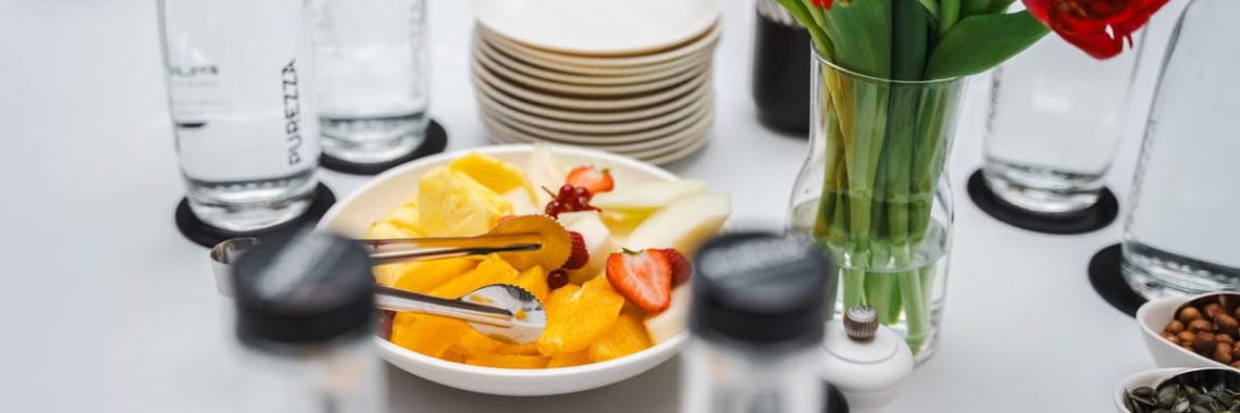 An elegant dining setup featuring fresh fruits and vibrant tulips, perfect for a healthy meal.